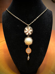 28" long gold plated chain with 4 gold/pearl/pink charms