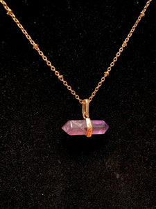 26" long gold plated chain with small purple stone